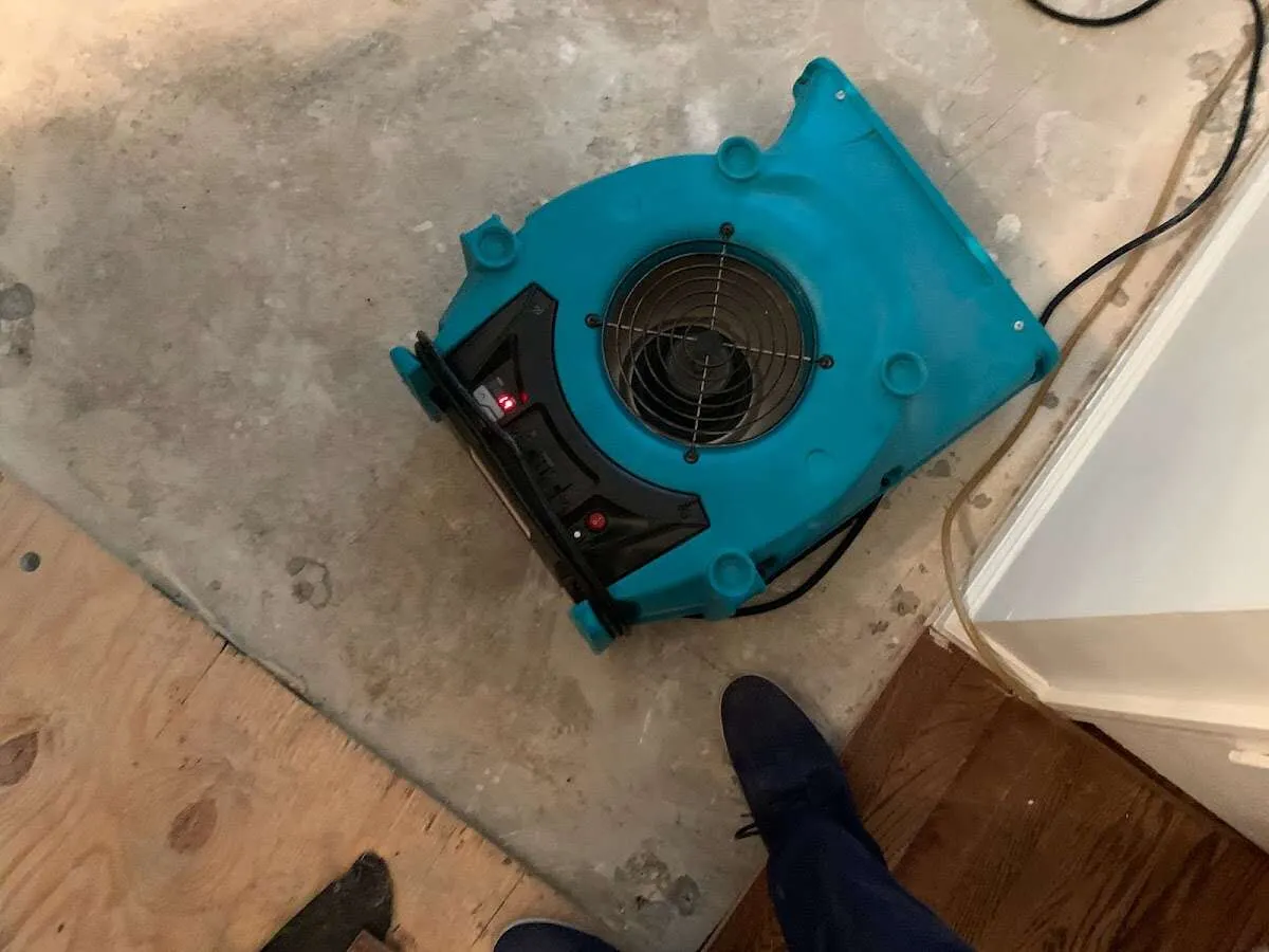 Air mover drying subfloor during Commercial Water Damage Restoration in Gunbarrel